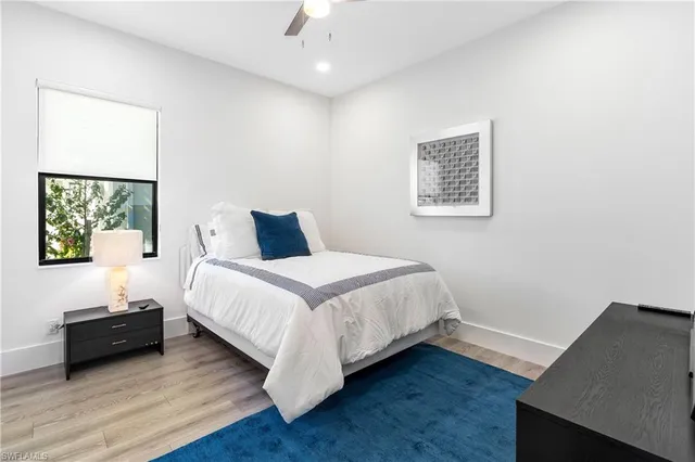 a bedroom with a bed and a night stand