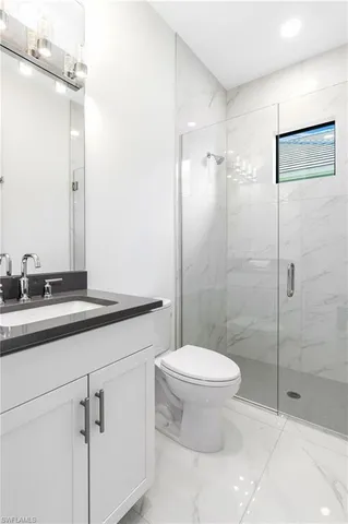 a bathroom with a toilet sink and shower