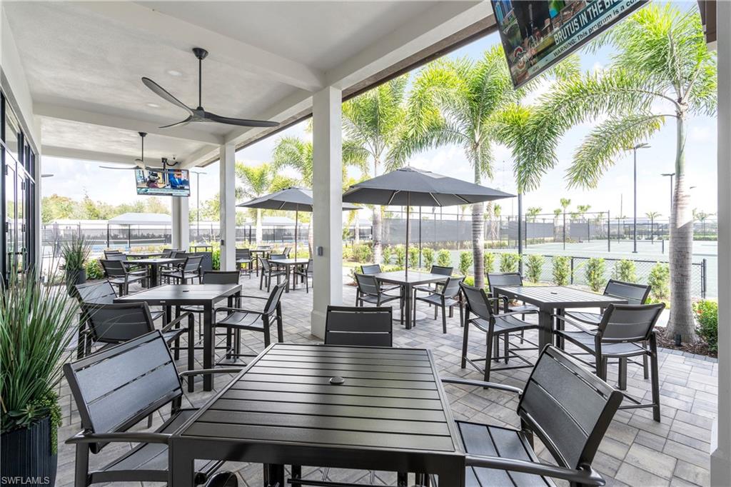 9675 Moonflower Court Naples, FL 34114 - Photo 28 of 32 View of patio featuring outdoor dining space and ceiling fan