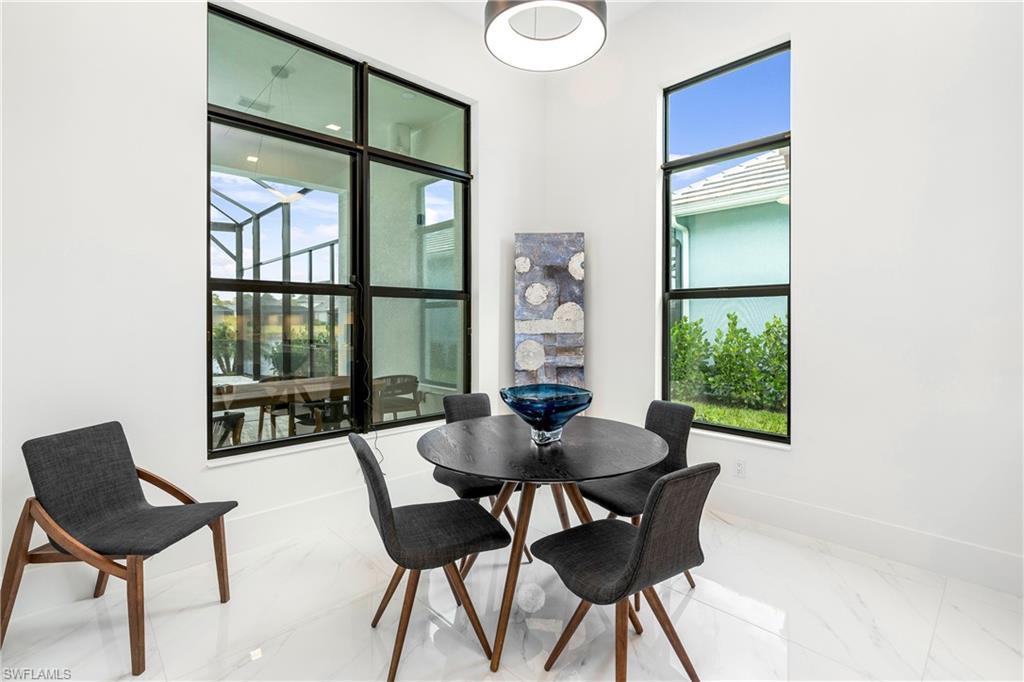 9675 Moonflower Court Naples, FL 34114 - Photo 9 of 32 Dining space featuring marble finish flooring