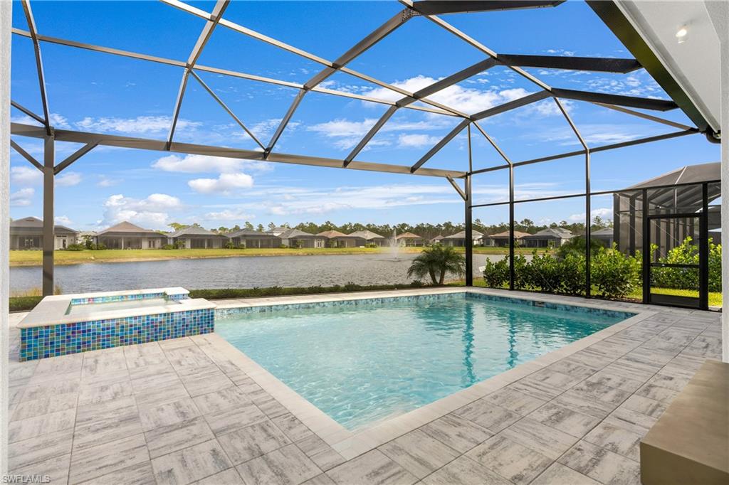 9675 Moonflower Court Naples, FL 34114 - Photo 10 of 32 View of swimming pool with a sunroom, glass enclosure, a residential view, a patio, and a water view
