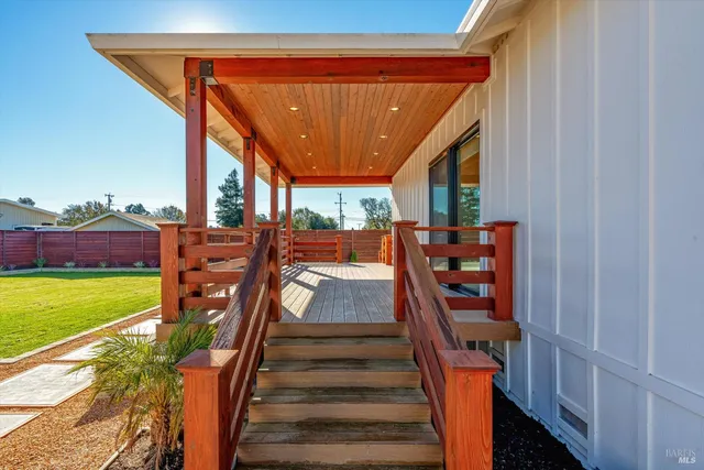 a living room with patio furniture and a potted plant