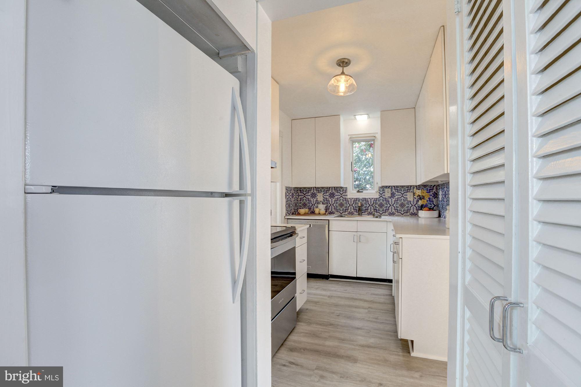 5325 Wakefield Road Bethesda, MD 20816 - Photo 11 of 27 White cabinets in the cheery kitchen.