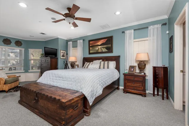 a bedroom with a bed dresser and a window