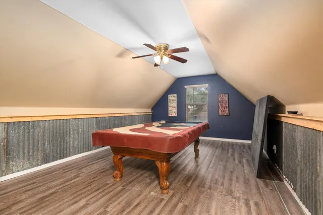 a workspace with furniture wooden floor fan and a chandelier