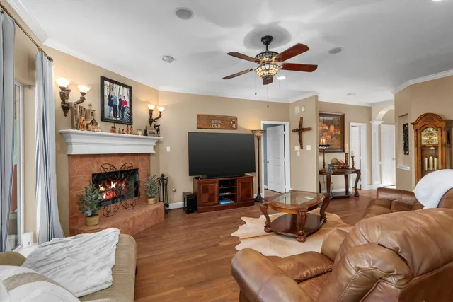 a living room with furniture a fireplace and a flat screen tv
