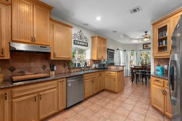 a kitchen with appliances cabinets and furniture