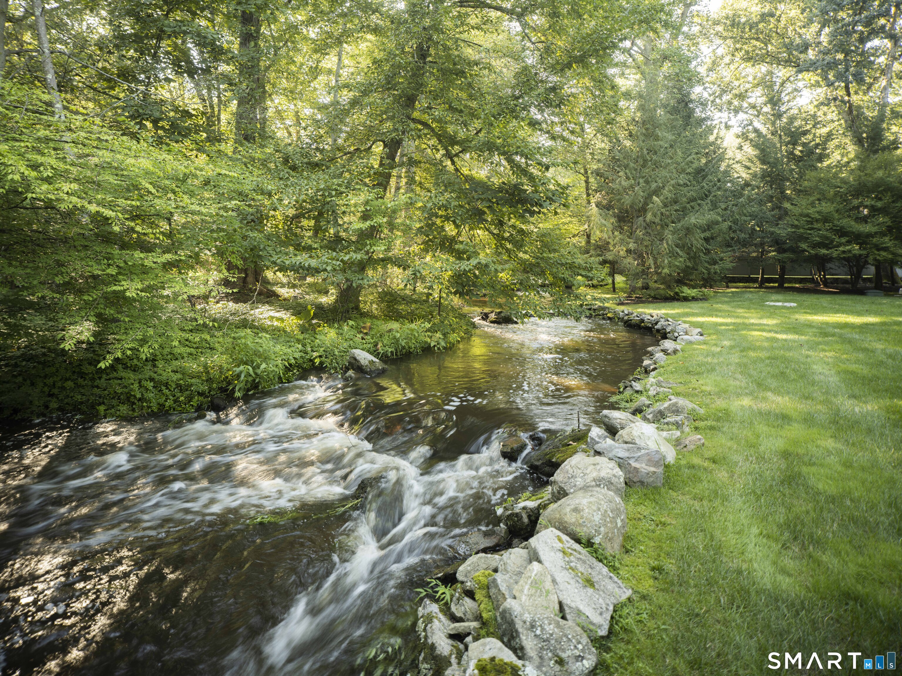 31 Stony Brook Road Westport, CT 06880 - Photo 34 of 36 a backyard of a house with lots of green space