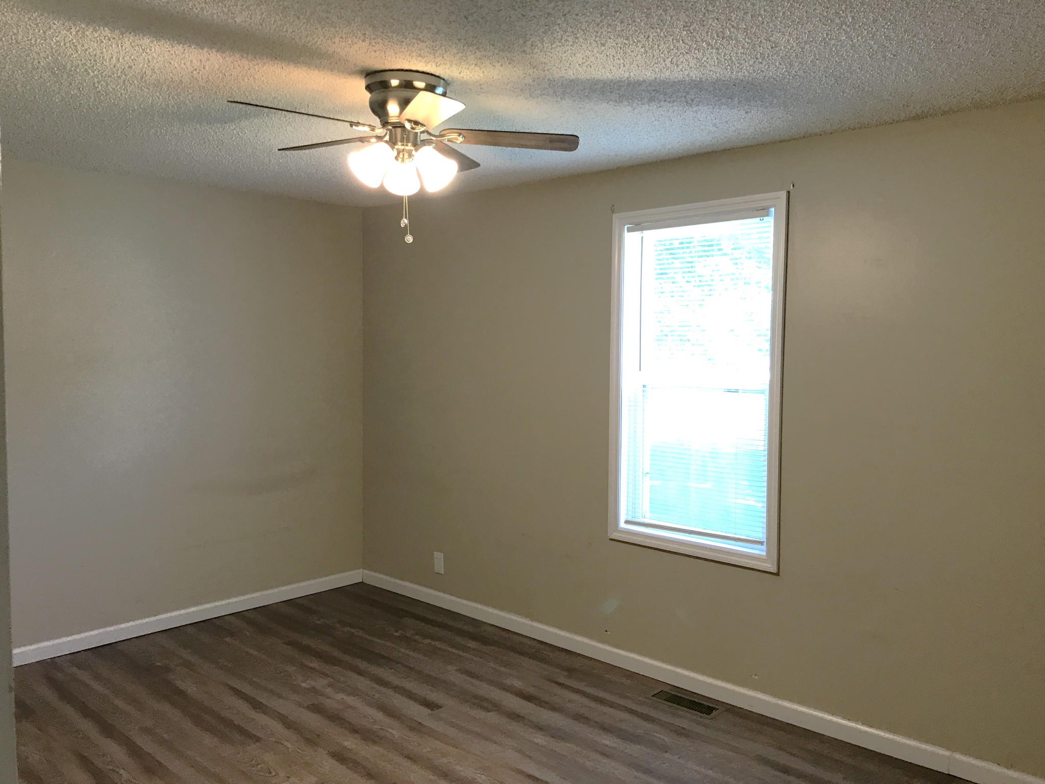 6558 Kari Drive Murfreesboro, TN 37129 - Photo 7 of 12 an empty room with wooden floor and windows