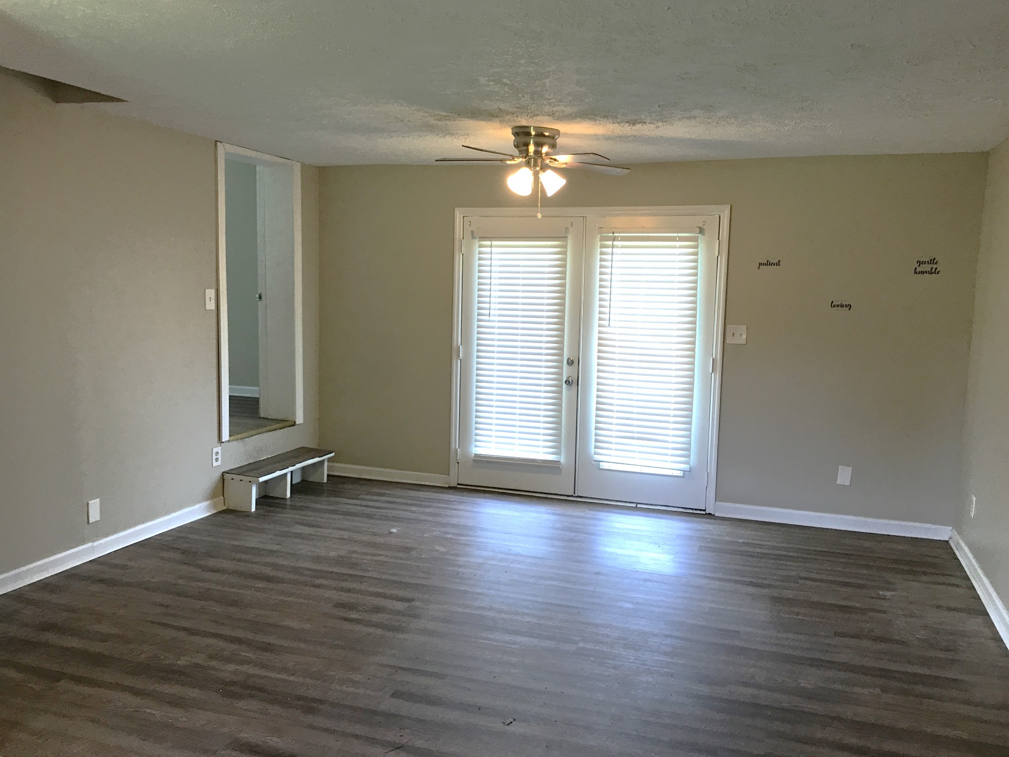 6558 Kari Drive Murfreesboro, TN 37129 - Photo 9 of 12 an empty room with wooden floor and windows