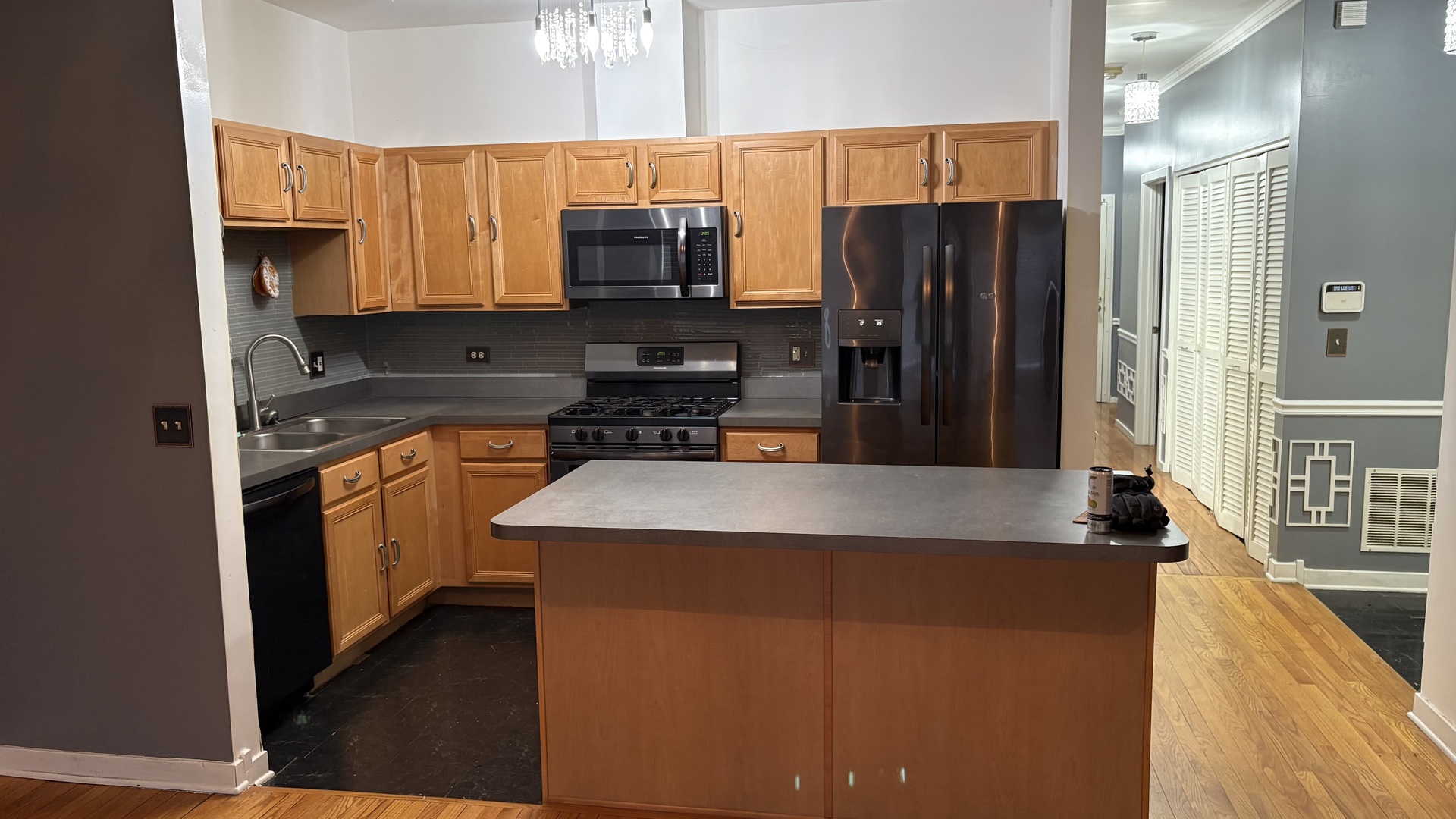 4100 South Drexel Boulevard, Unit 1B Chicago, IL 60653 - Photo 2 of 7 a kitchen with kitchen island granite countertop a sink a stove and a refrigerator