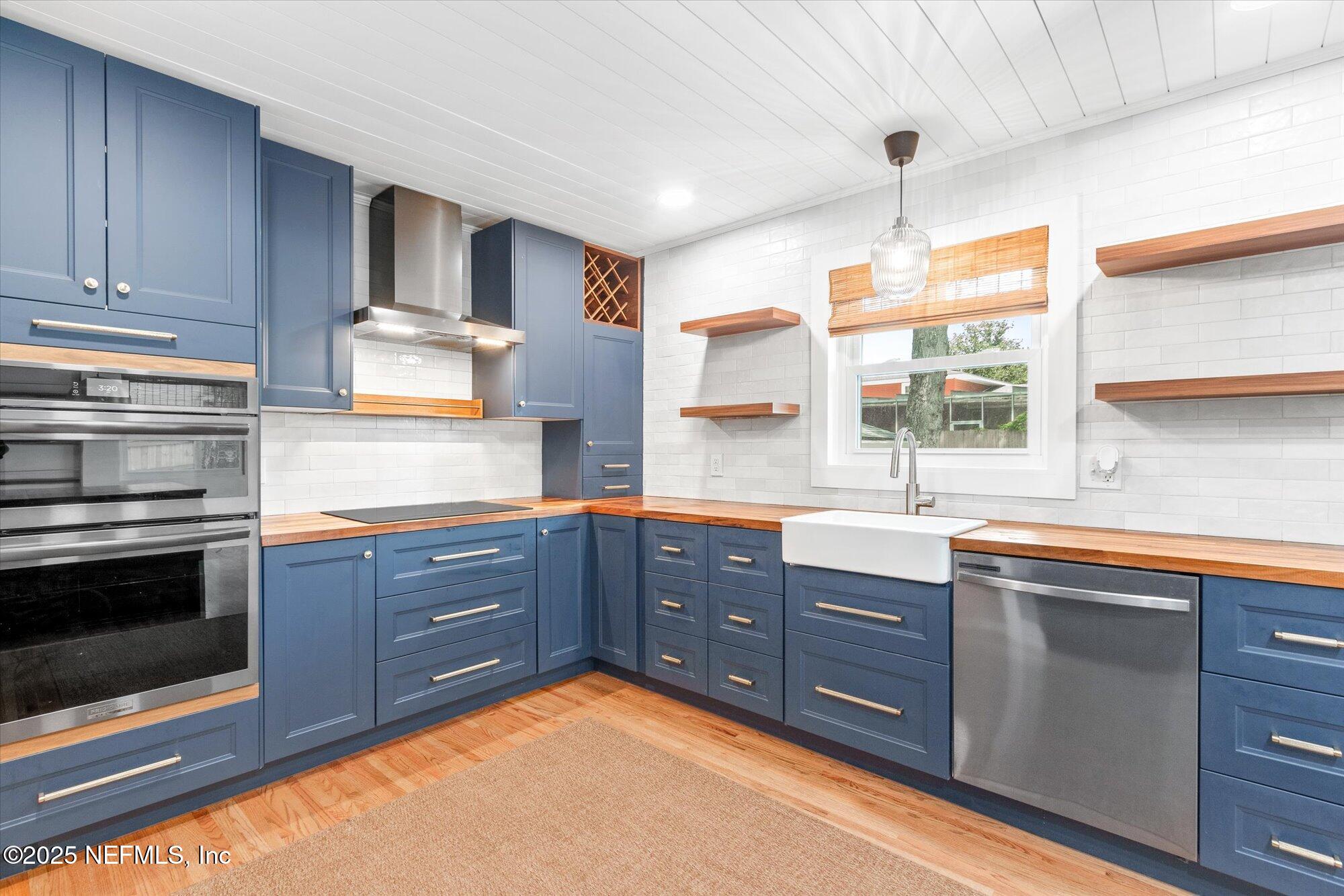 4045 Bess Road Jacksonville, FL 32277 - Photo 3 of 71 a kitchen with stainless steel appliances granite countertop a sink a stove and cabinets