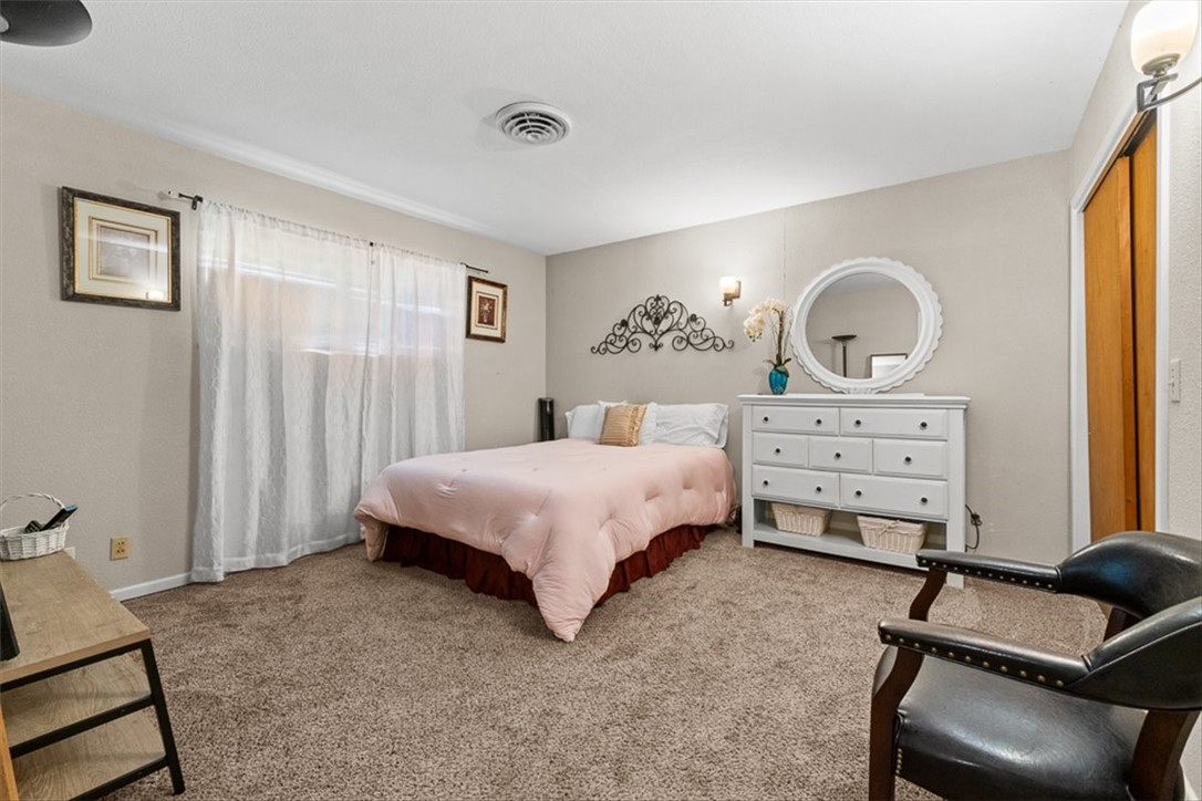 9675 County Road 325 Mathis, TX 78368 - Photo 22 of 29 a bedroom with a bed and a dresser