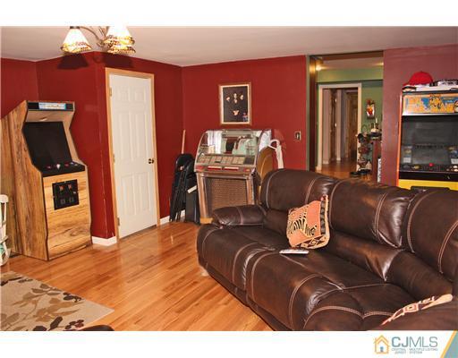 36 Runnymede Road Colonia, NJ 07067 - Photo 15 of 25 a living room with furniture and a flat screen tv
