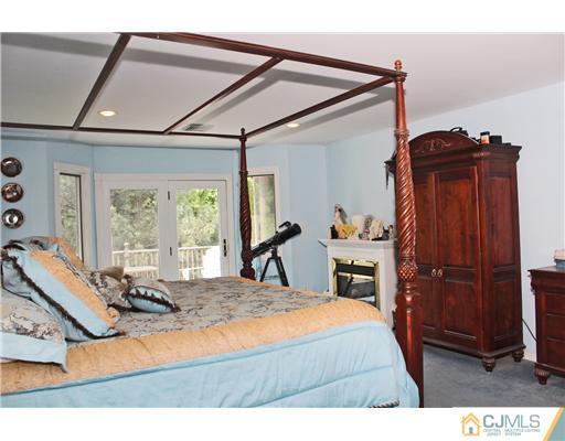36 Runnymede Road Colonia, NJ 07067 - Photo 17 of 25 a bedroom with a bed and wooden floor