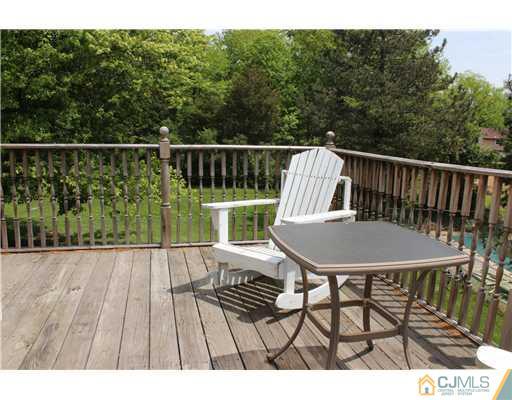 36 Runnymede Road Colonia, NJ 07067 - Photo 19 of 25 a view of a chairs and table on the wooden floor