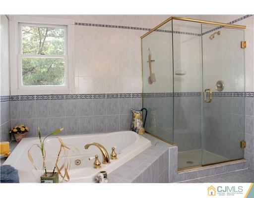 36 Runnymede Road Colonia, NJ 07067 - Photo 20 of 25 a bathroom with a bathtub and a shower