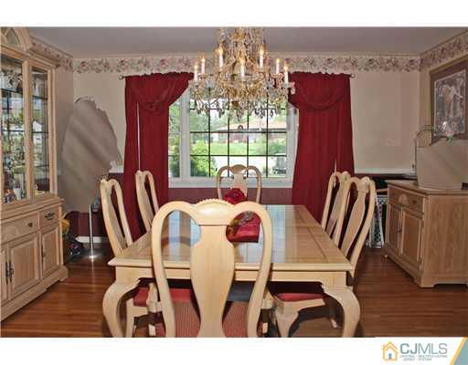 36 Runnymede Road Colonia, NJ 07067 - Photo 3 of 25 a dining room with furniture a chandelier and wooden floor