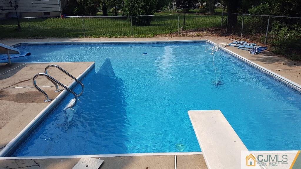 36 Runnymede Road Colonia, NJ 07067 - Photo 24 of 25 a view of swimming pool with a chair and a floor to ceiling window
