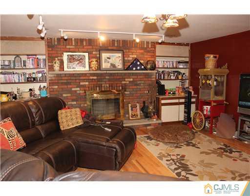 36 Runnymede Road Colonia, NJ 07067 - Photo 5 of 25 a living room with furniture a fireplace and a large window