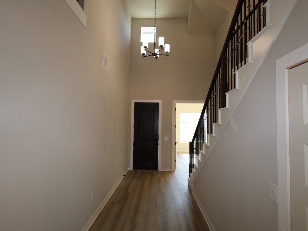3713 Helena Way Leander, TX 78641 - Photo 12 of 28 a view of a hallway with wooden floor and staircase