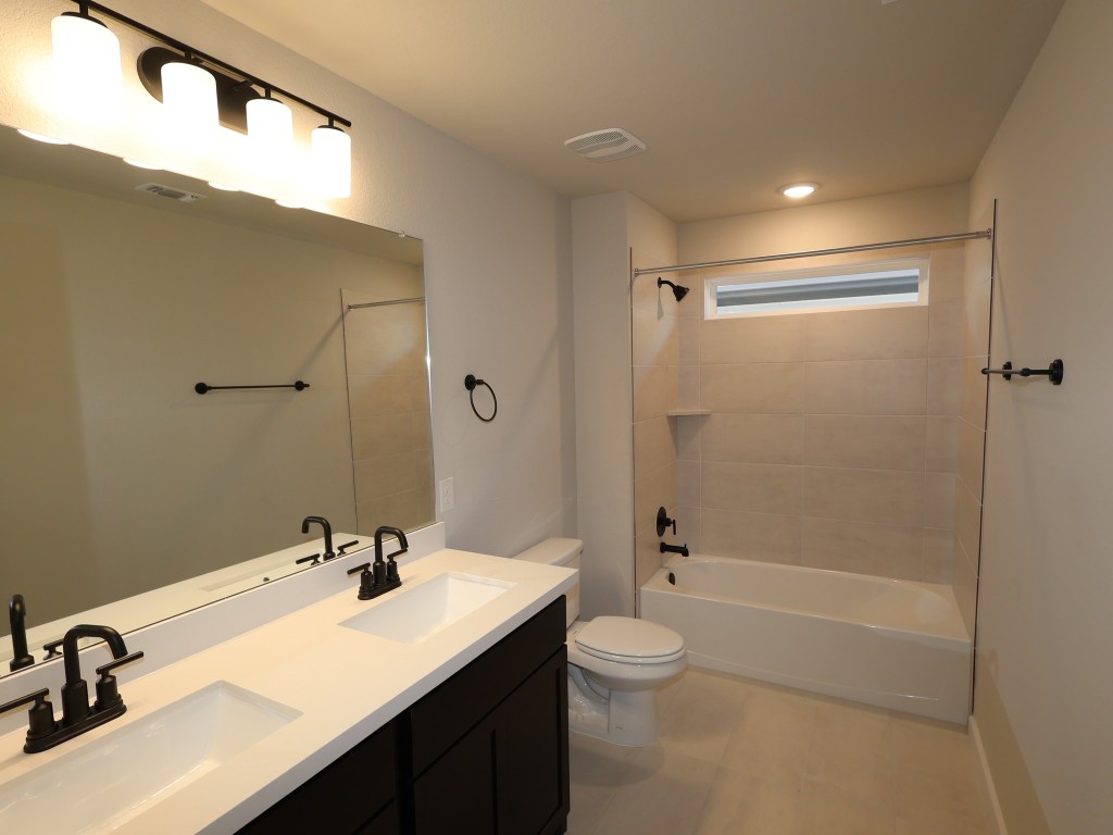 3713 Helena Way Leander, TX 78641 - Photo 21 of 28 a bathroom with a sink double vanity granite toilet tub and shower