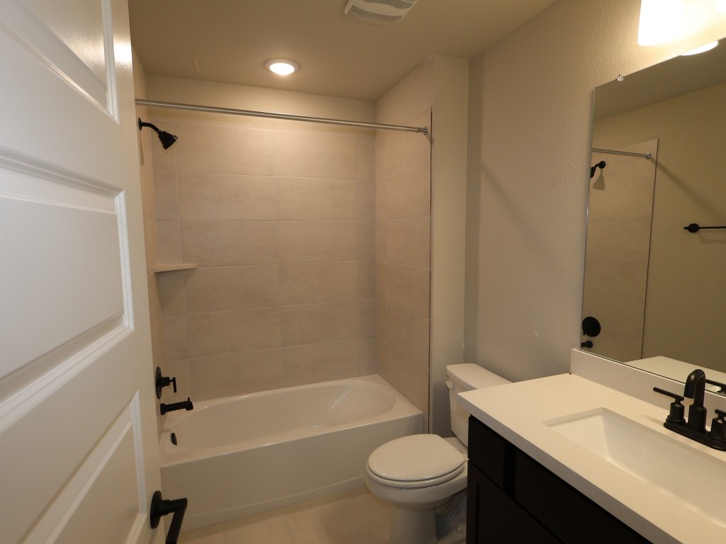 3713 Helena Way Leander, TX 78641 - Photo 24 of 28 a bathroom with a sink toilet vanity and shower