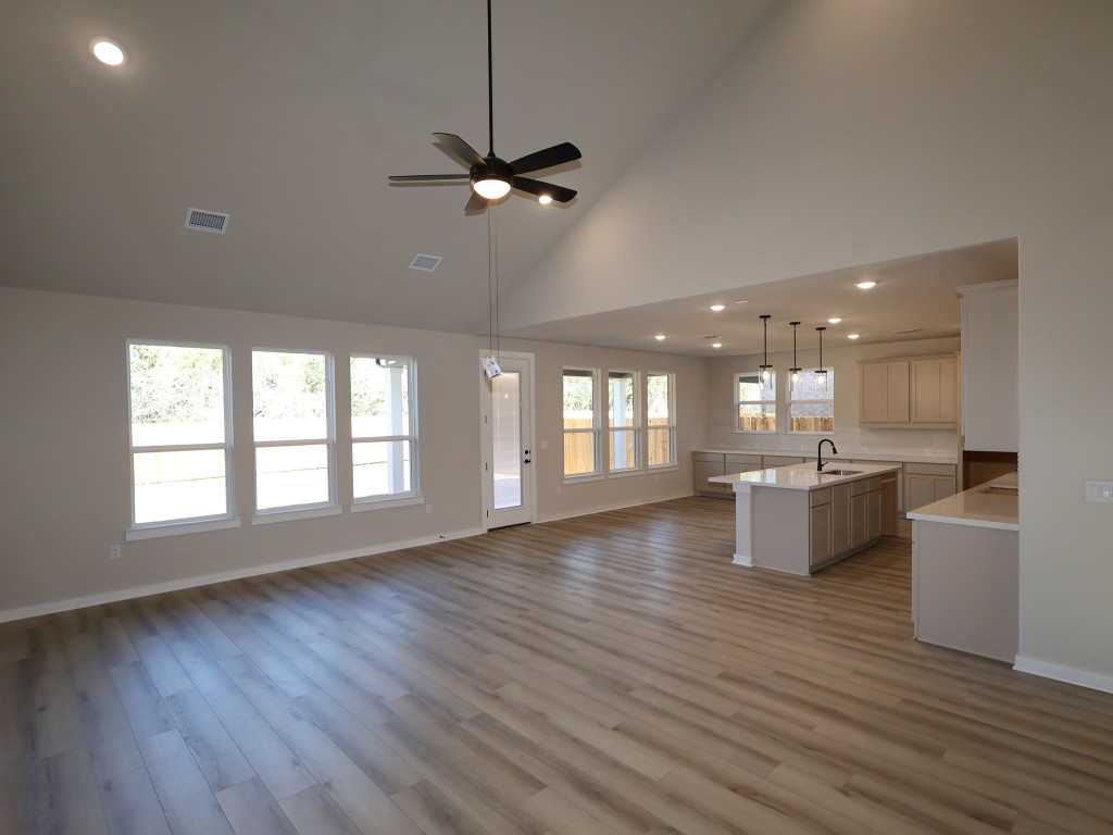 3713 Helena Way Leander, TX 78641 - Photo 3 of 28 a living room with hard wood floors and a kitchen
