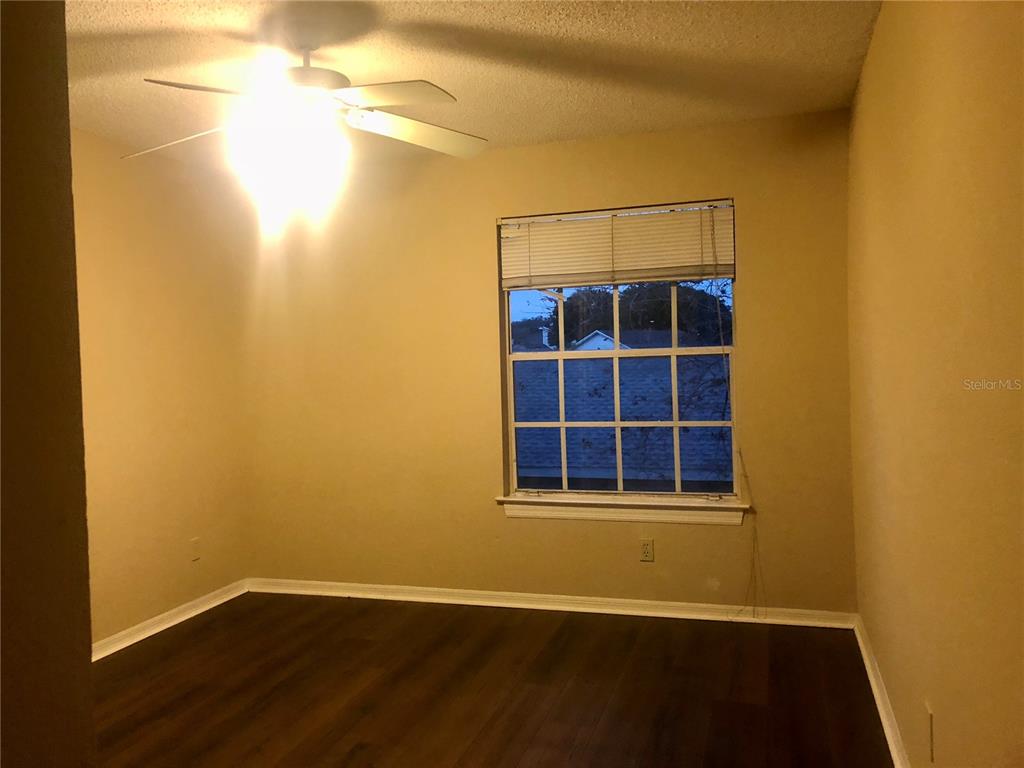1049 South Hiawassee Road, Unit 3422 Orlando, FL 32835 - Photo 11 of 15 a view of an empty room with wooden floor and a window