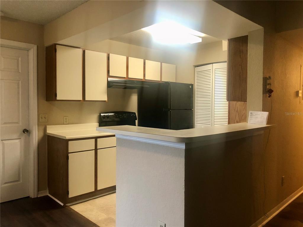 1049 South Hiawassee Road, Unit 3422 Orlando, FL 32835 - Photo 4 of 15 a kitchen with a refrigerator and a window