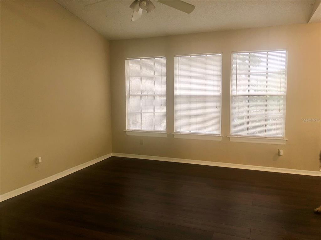 1049 South Hiawassee Road, Unit 3422 Orlando, FL 32835 - Photo 8 of 15 an empty room with wooden floor and windows