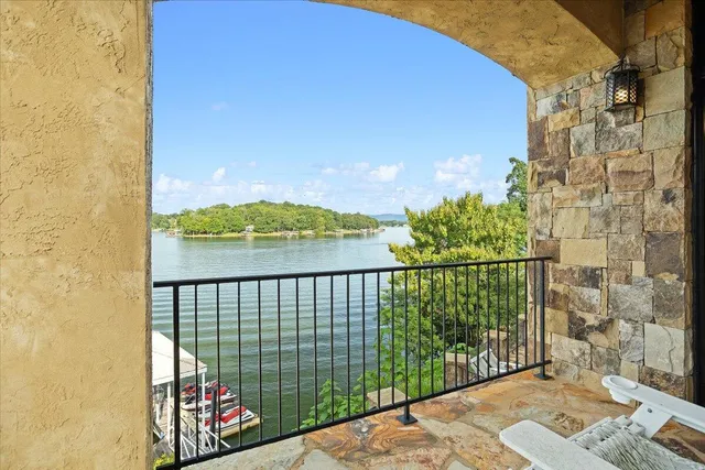 a view of a hallway with wooden floor windows and a livingroom