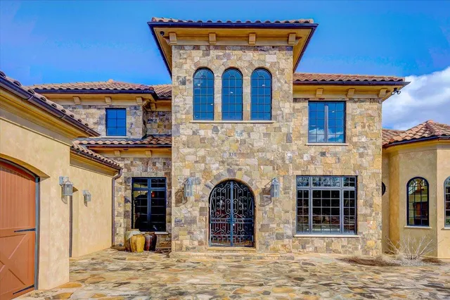 a living room with furniture floor to ceiling window and a flat screen tv