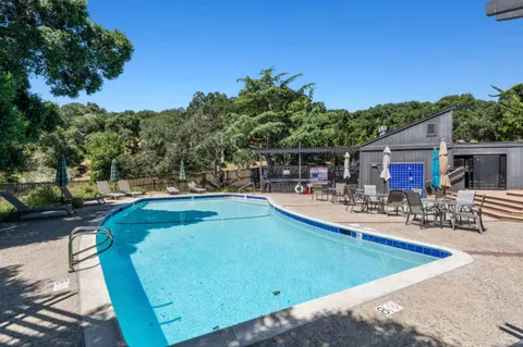 a view of a swimming pool with chairs