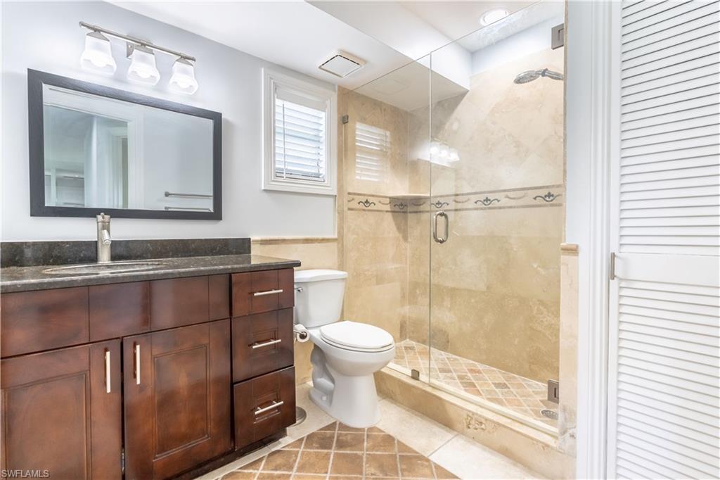 2100 55th Street Southwest Naples, FL 34116 - Photo 40 of 50 a bathroom with a sink a toilet a mirror and shower