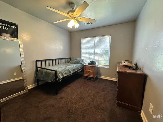 a bedroom with bed and window