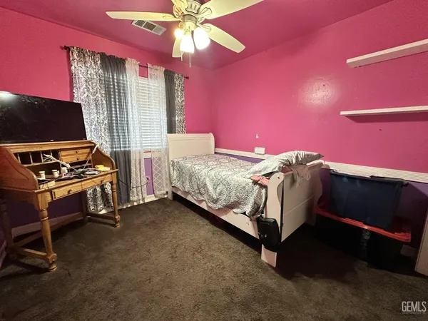 a bed room with a bed and a television