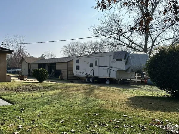a view of a house with a swimming pool and sitting area