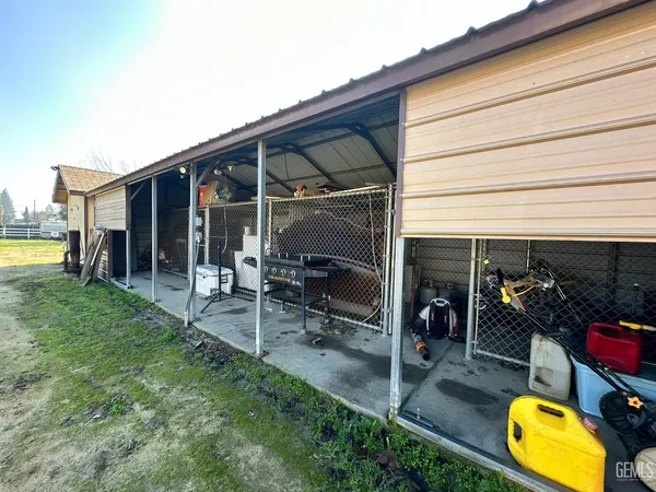 a view of a chair and table in patio with a barbeque grill