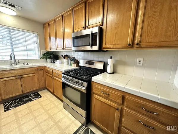 a kitchen with sink cabinets and window