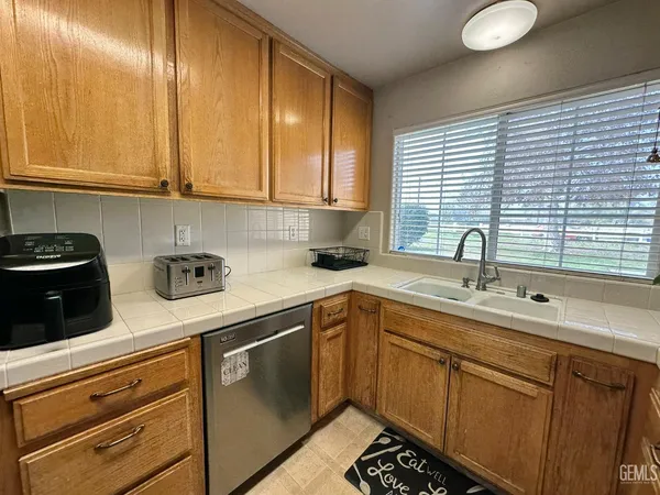 a kitchen with stainless steel appliances granite countertop a sink a stove and cabinets
