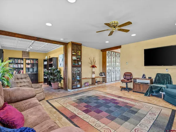 a dining room with furniture and a large window