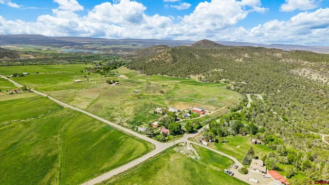 a backyard of a house with lots of green space and a fountain