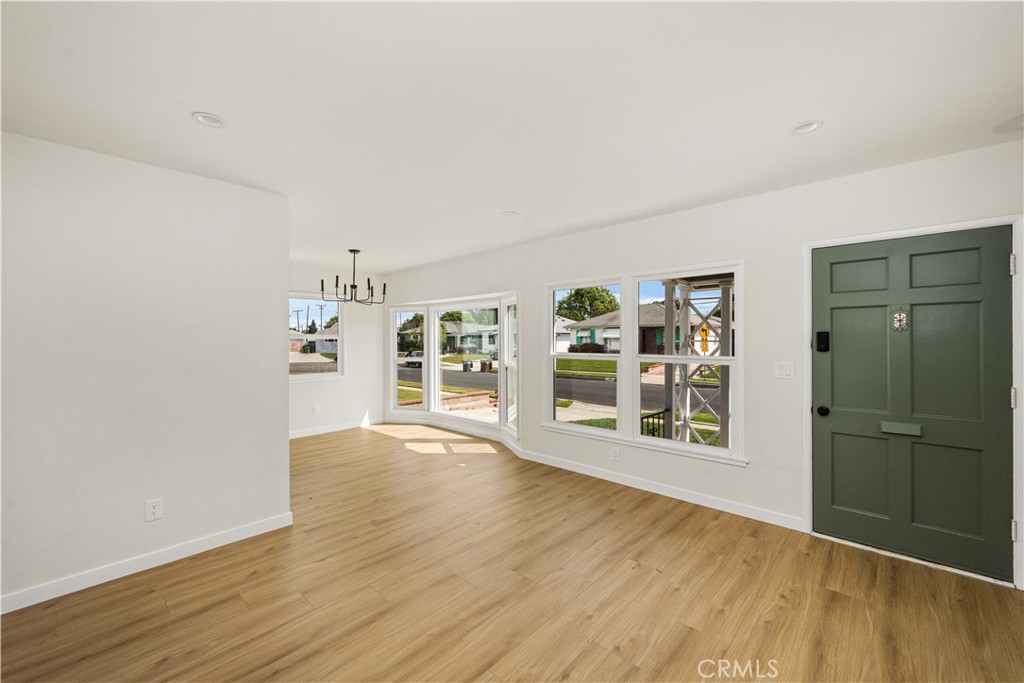 1013 West 138th Street Compton, CA 90222 - Photo 5 of 30 an empty room with wooden floor and door