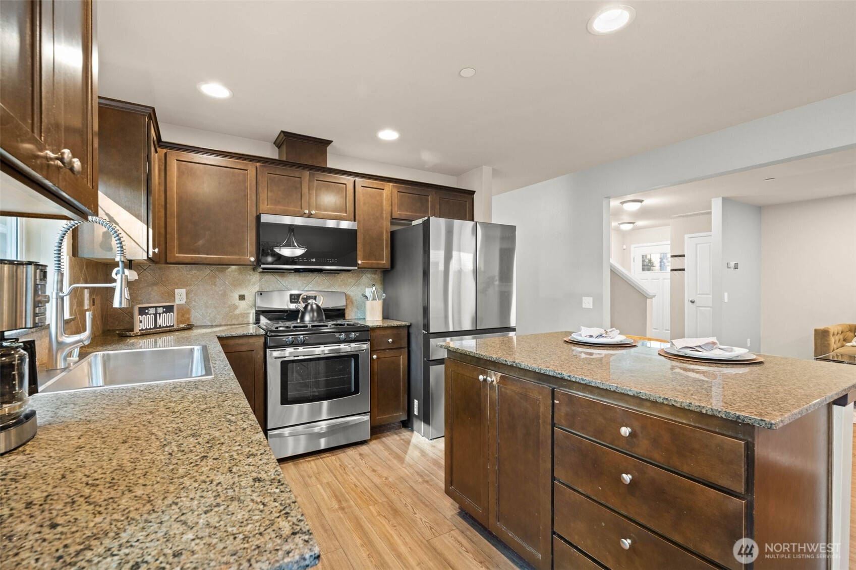 19312 1st Avenue West, Unit 4 Bothell, WA 98012 - Photo 12 of 32 a kitchen with stainless steel appliances granite countertop a sink a stove and a refrigerator