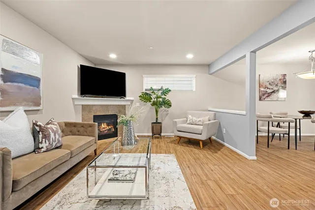 a living room with furniture a fireplace and a flat screen tv