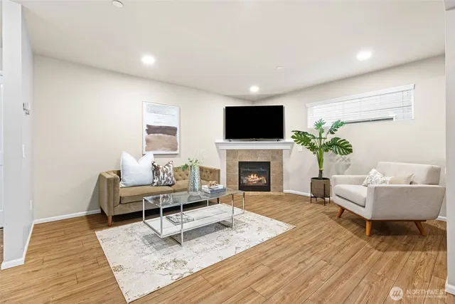 a living room with furniture a rug and a flat screen tv