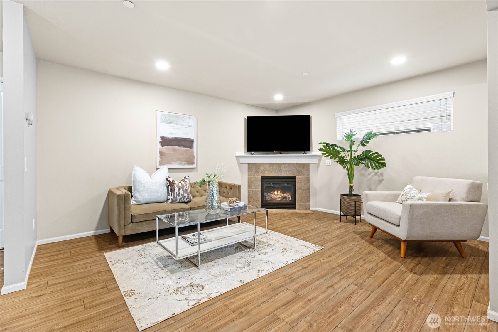 19312 1st Avenue West, Unit 4 Bothell, WA 98012 - Photo 7 of 32 a living room with furniture a rug and a flat screen tv