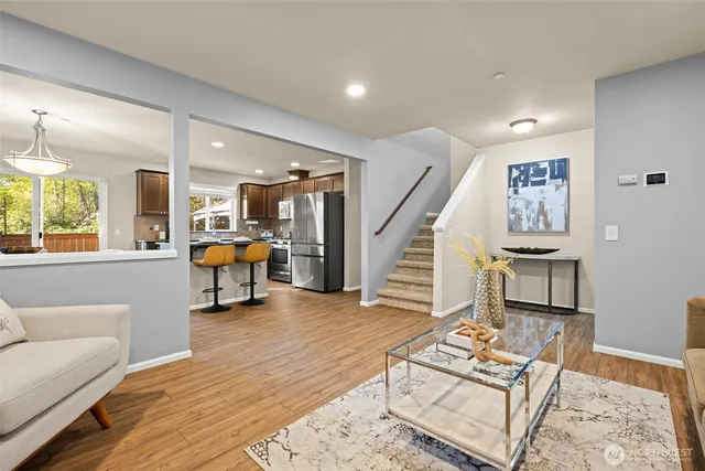 a living room with furniture and a wooden floor