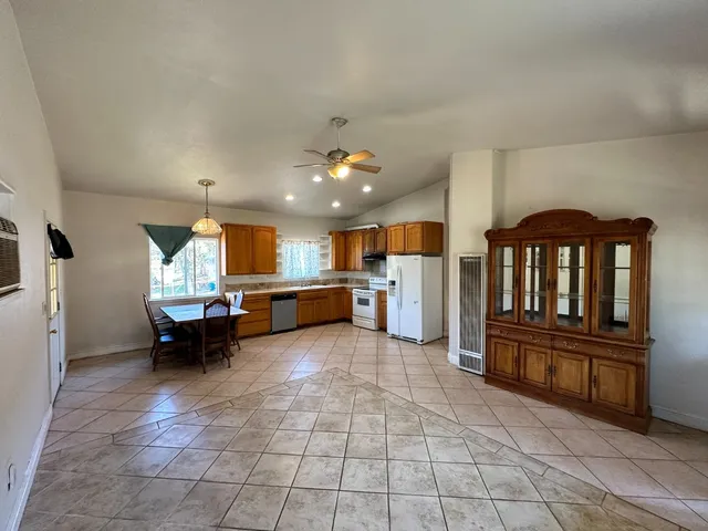 a kitchen with a refrigerator and a counter top space